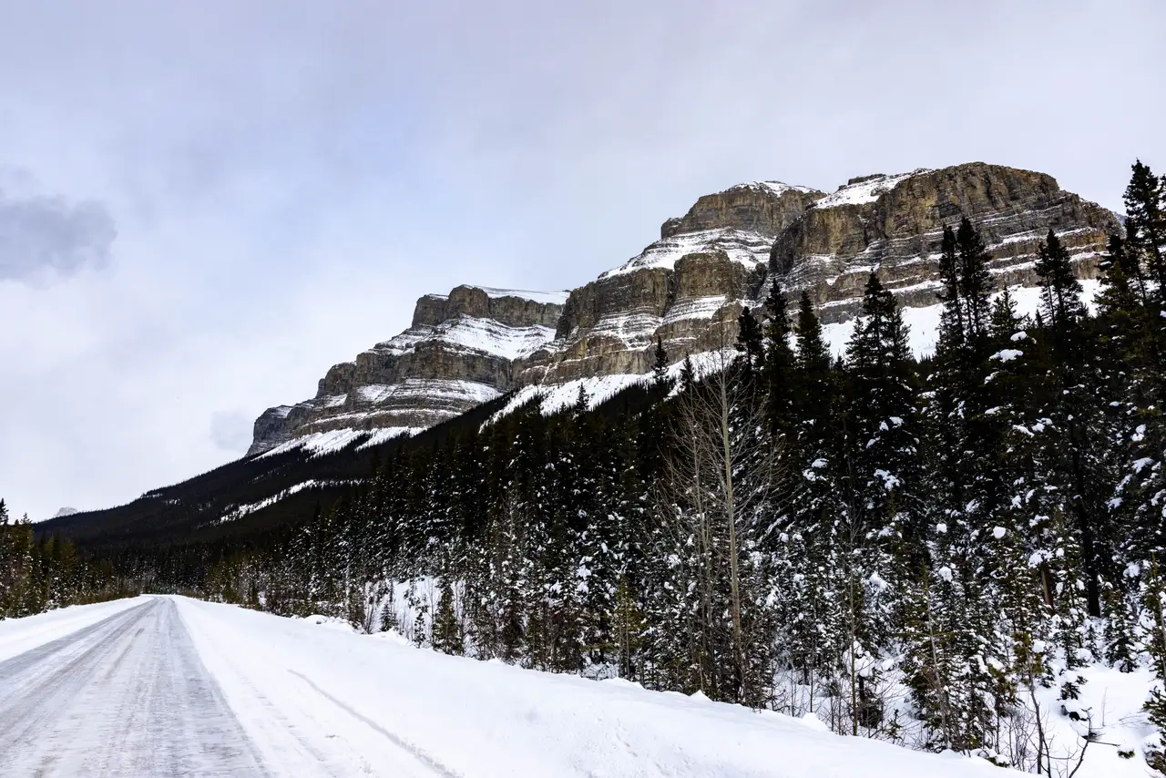 Fine-art photograph, “Snowy Road Beneath a Rocky Mountain - 5M2A0350.JPG,” from the British Columbia - Banff collection.
