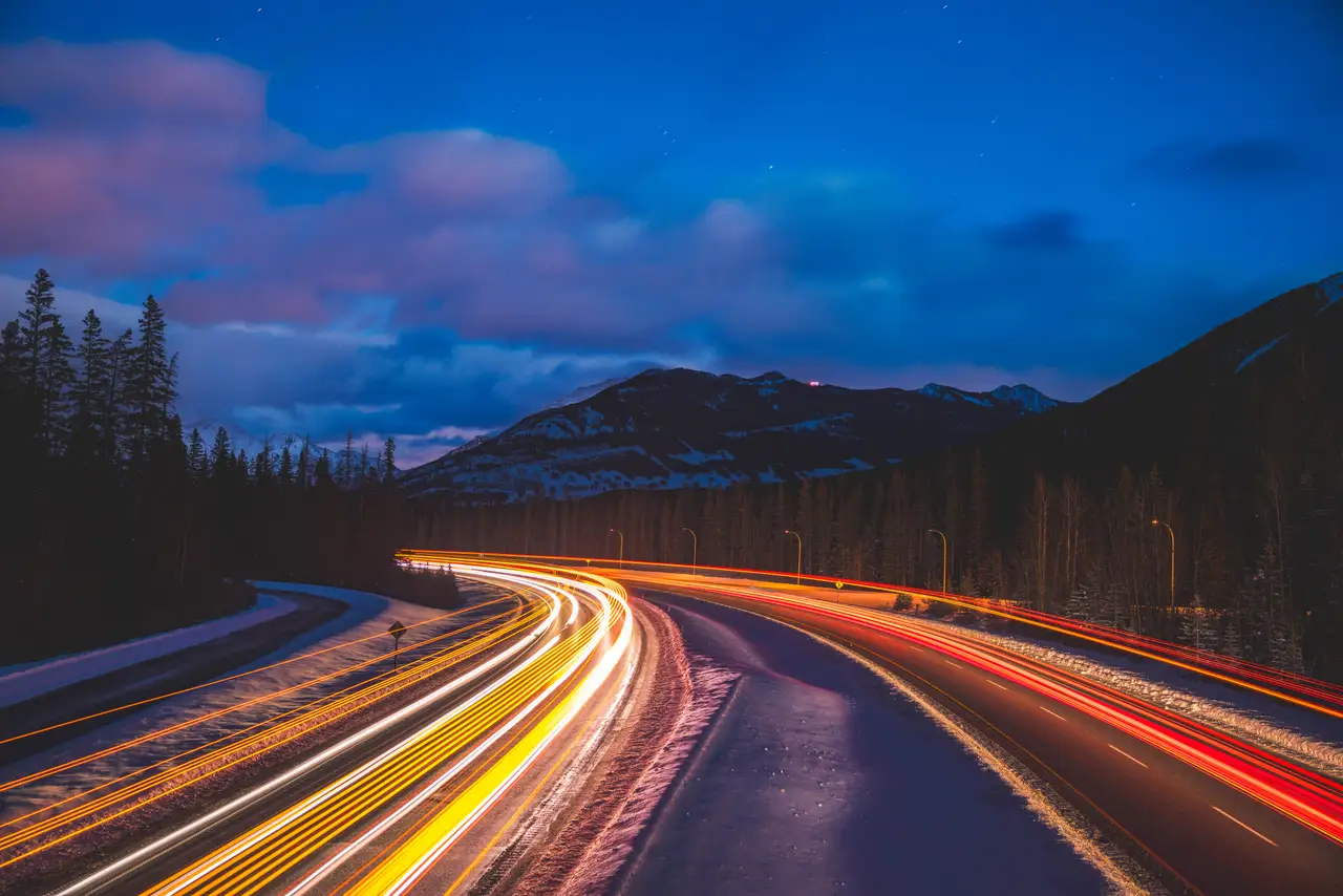 Fine-art photograph, “Banff Highway Light Trails Under Purple Clouds - 5M2A8869.JPG,” from the British Columbia - Banff collection.