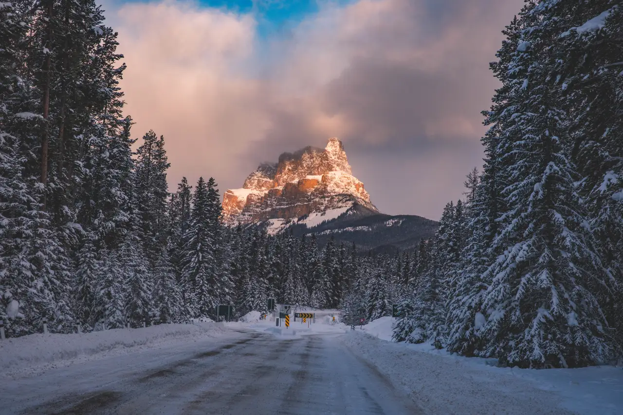 Fine-art photograph, “Snowy Banff Road Framing a Sunlit Peak - 5M2A8934.JPG,” from the British Columbia - Banff collection.