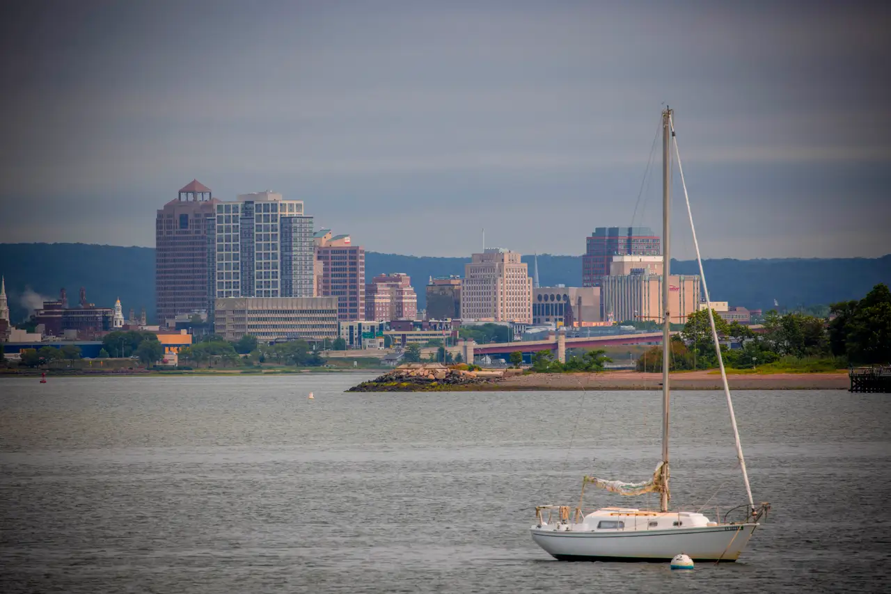 Fine-art photograph, “Sailboat at Anchor Before the New Haven Waterfront in Evening Light - RFIV0630.JPG,” from the Connecticut collection.