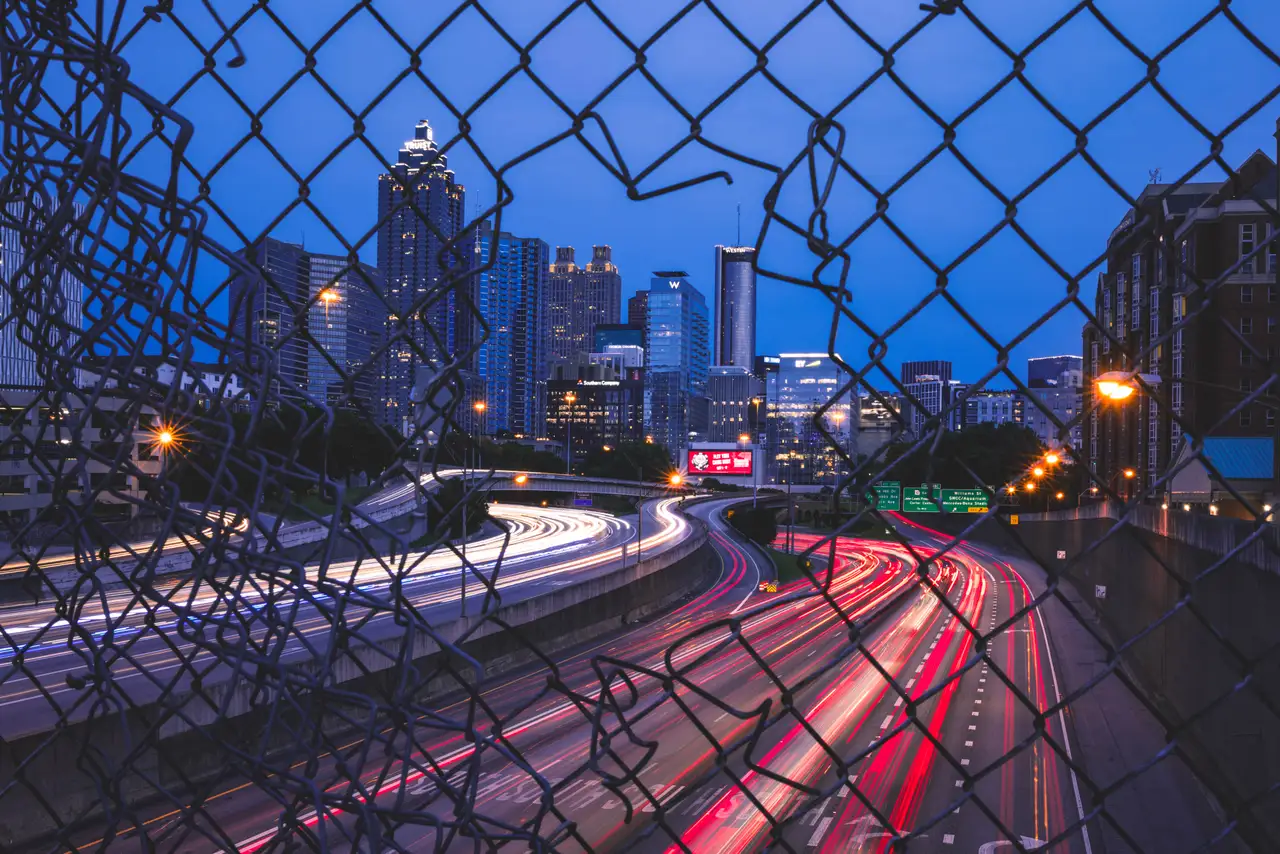 Fine-art photograph, “Atlanta Midtown Highway Light Trails Through a Fence, Evening Momentum - _FIV2182.JPG,” from the Georgia - ATL collection.