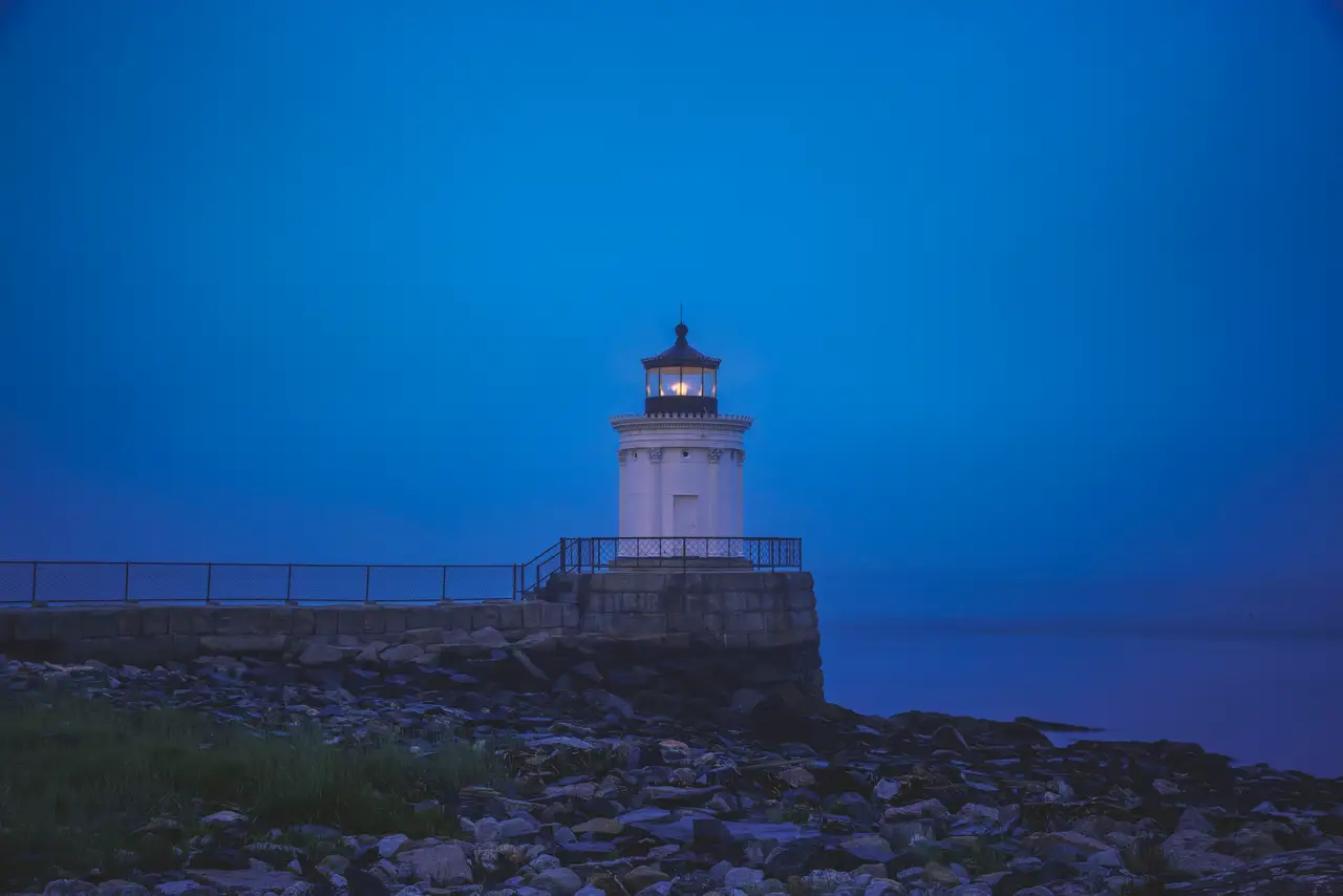 Fine-art photograph, “Bug Light Glowing Above Portland Harbor at Blue Hour - RFIV1273.JPG,” from the Maine collection.