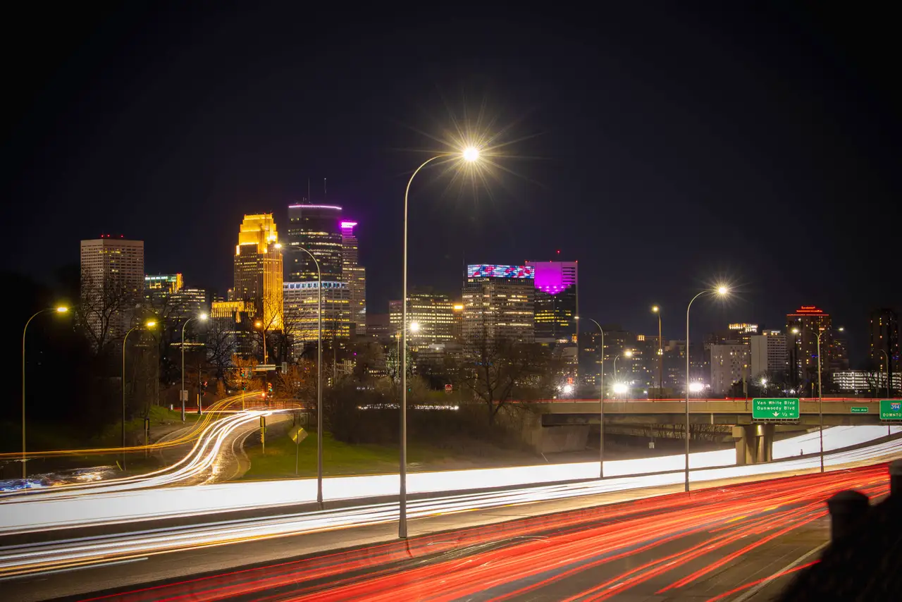 Fine-art photograph, “Minneapolis Skyline Light Trails, Distant Glow - RFIV8463.JPG,” from the Minnesota collection.