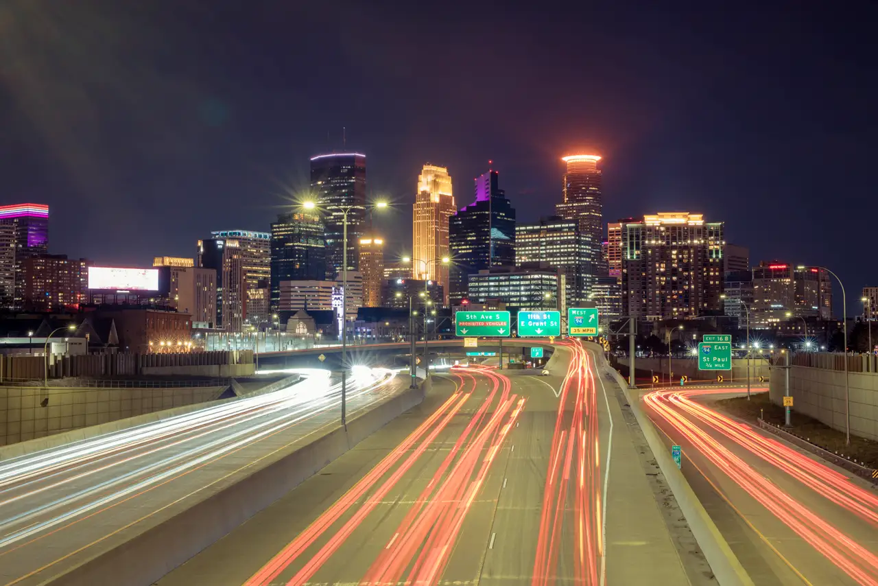 Fine-art photograph, “Minneapolis Skyline Light Trails, Distant Glow - RFIV8615.JPG,” from the Minnesota collection.