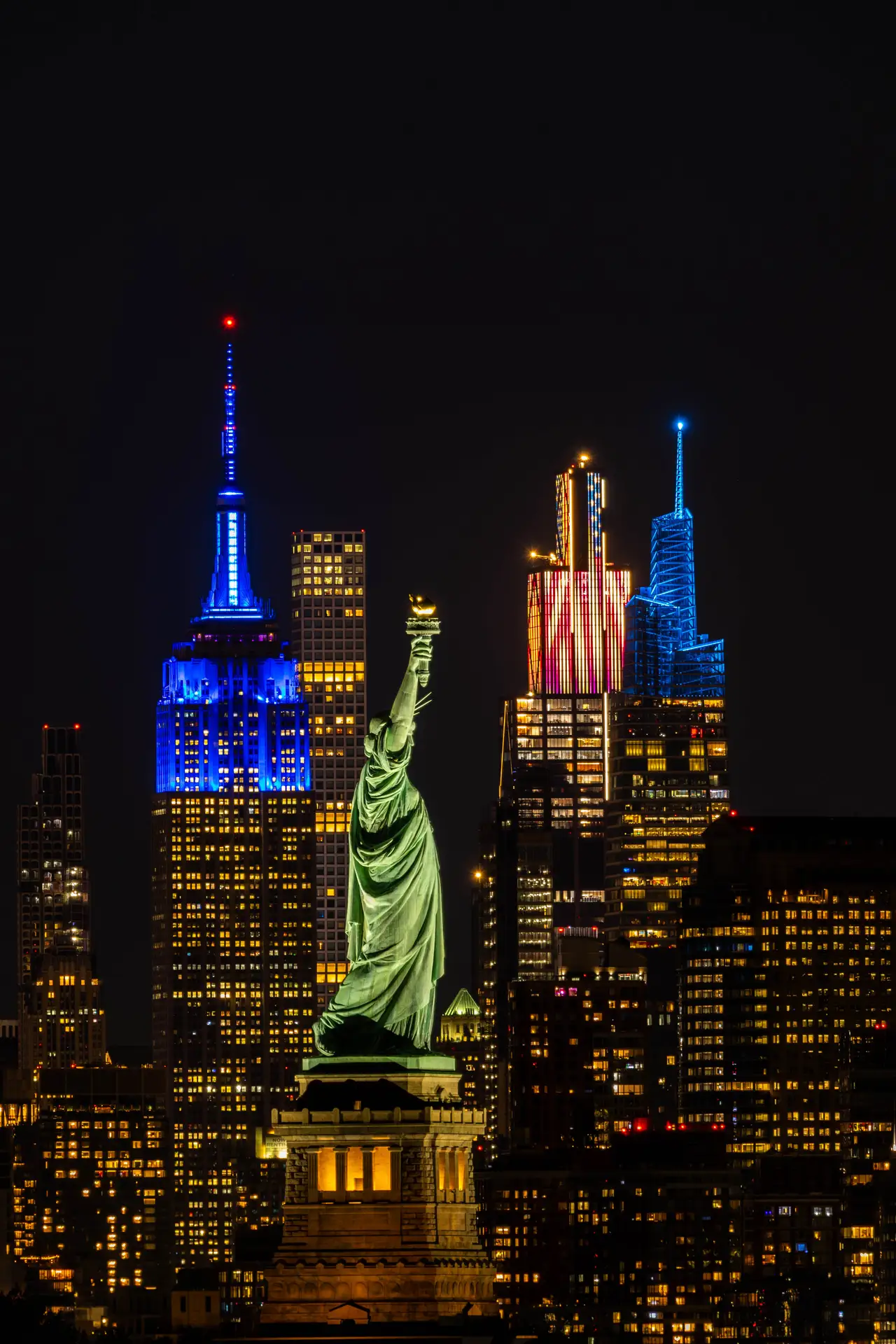 Fine-art photograph, “Statue of Liberty and Empire State in Patriotic Light, Night Passage - _FIV8325.JPG,” from the New York City collection.