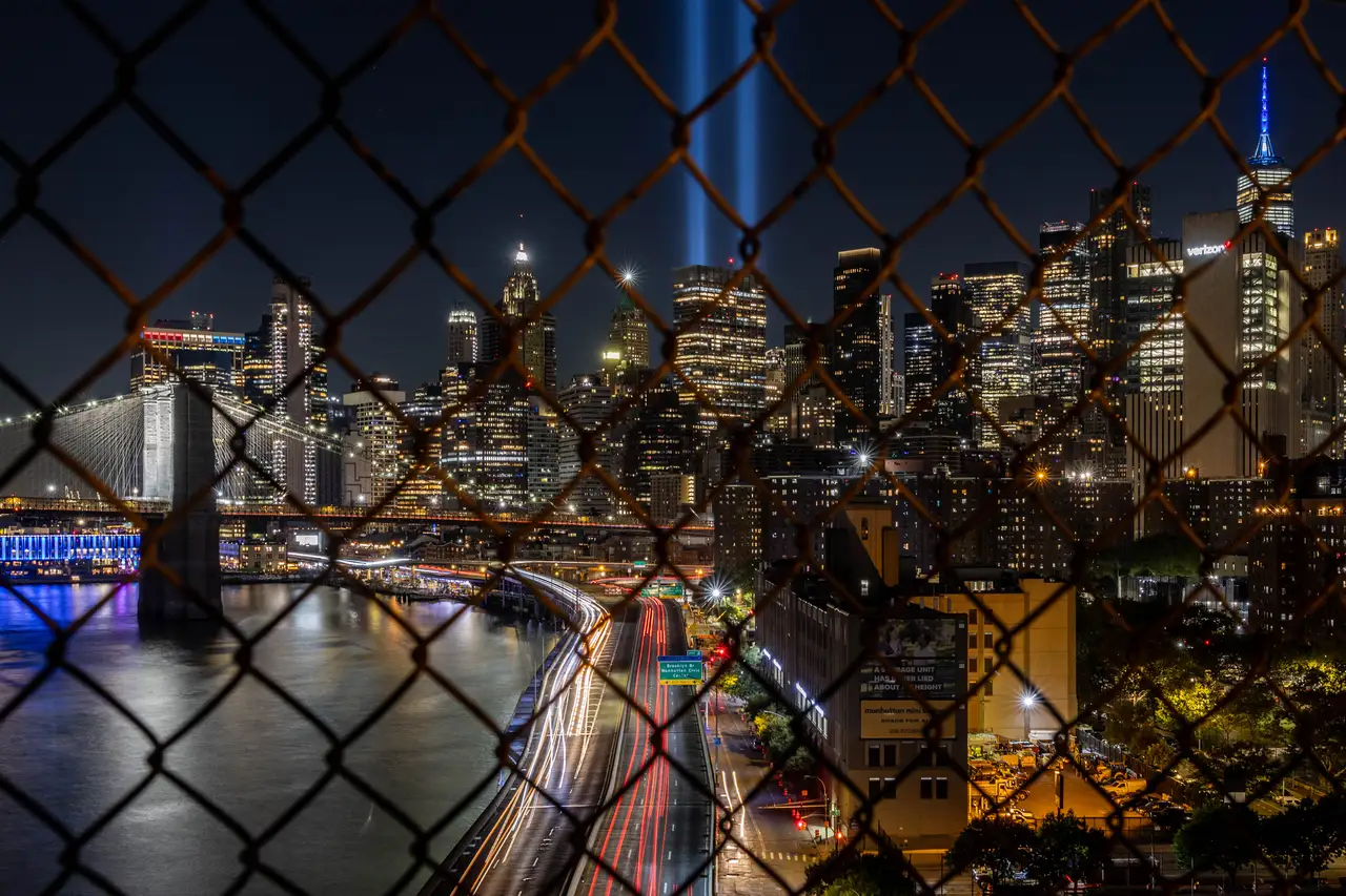 Fine-art photograph, “Brooklyn Bridge Light Trails Through a Fence - _FIV8362.JPG,” from the New York City collection.