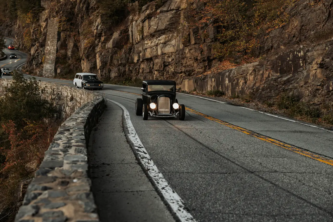 Fine-art photograph, “Adirondack Vintage Car Beneath Rock Cliffs - 5M2A1308.JPG,” from the New York State collection.