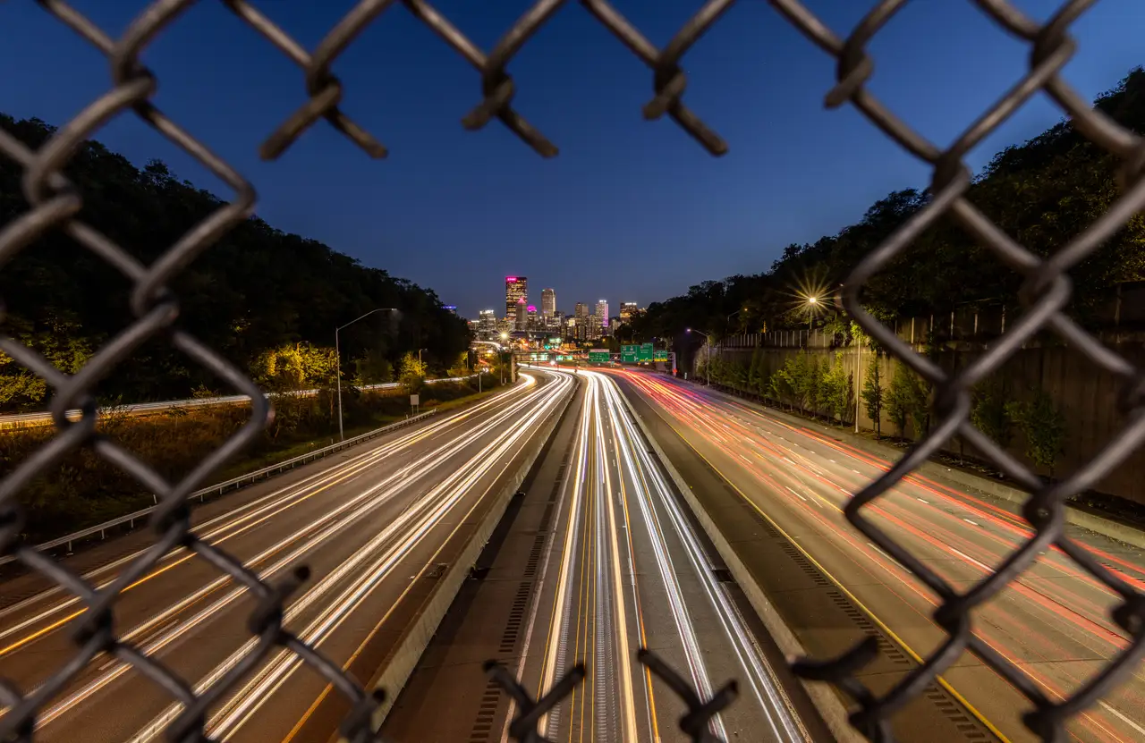 Fine-art photograph, “Pittsburgh Highway Light Trails Through a Fence, Midnight Current - 5M2A1525,” from the Pennsylvania - Pittsburgh collection.