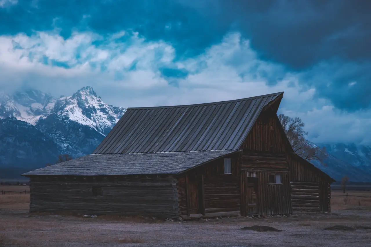 Fine-art photograph, “Moulton Barn and Tetons Under Storm Clouds - 5M2A3902,” from the Wyoming collection.